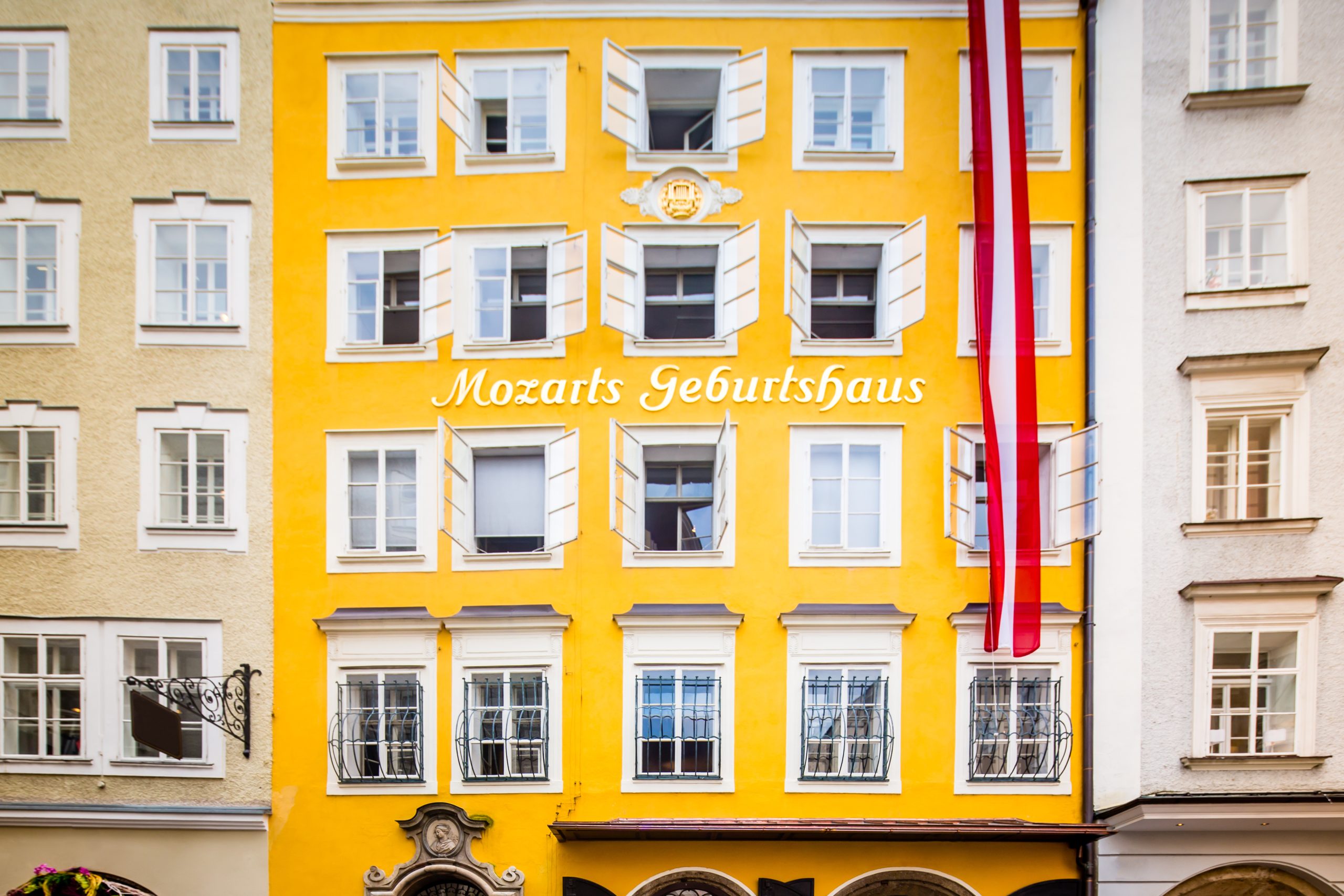 Wolfgang Amadeus Mozart's Birthplace - the house where Mozart was born  - Mozarts Geburtshaus with Austrian Flag in the famous Getreidegasse 9, old town street in Salzburg, Austria